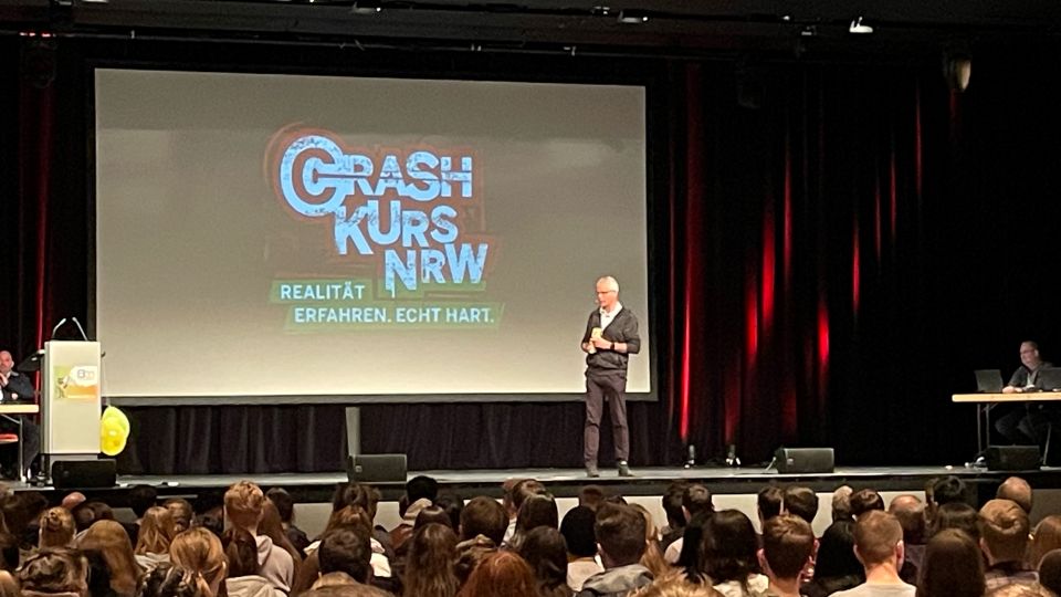 Das Bild zeigt PHK Michael Klein auf der Bühne der Stadthalle Attendorn bei der Eröffnung der Crash-Kurs-NRW-Sasison 2022.